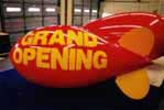 Advertising blimp with Grand Opening lettering